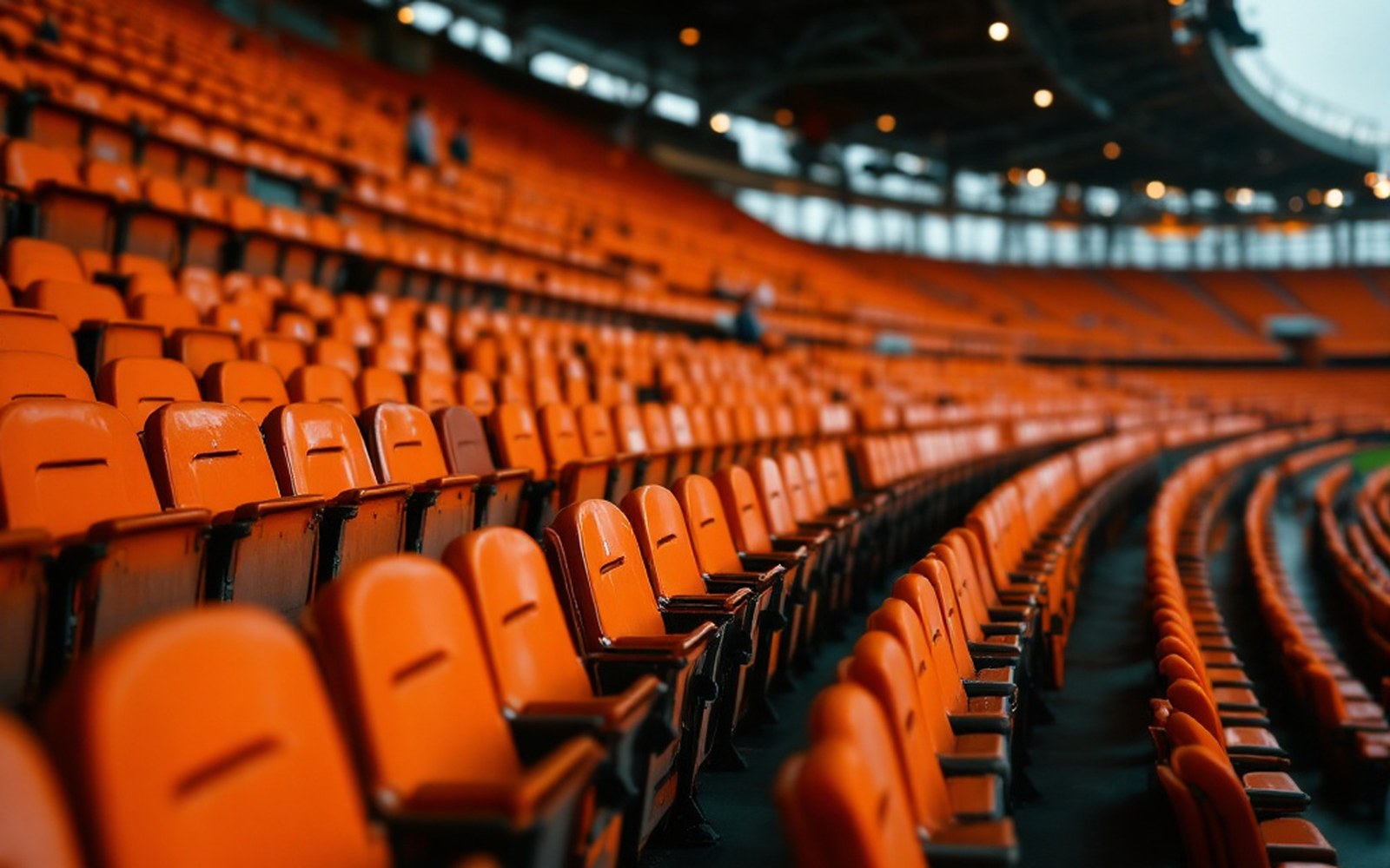Tightly framed rows of empty stadium seats in one saturated orange